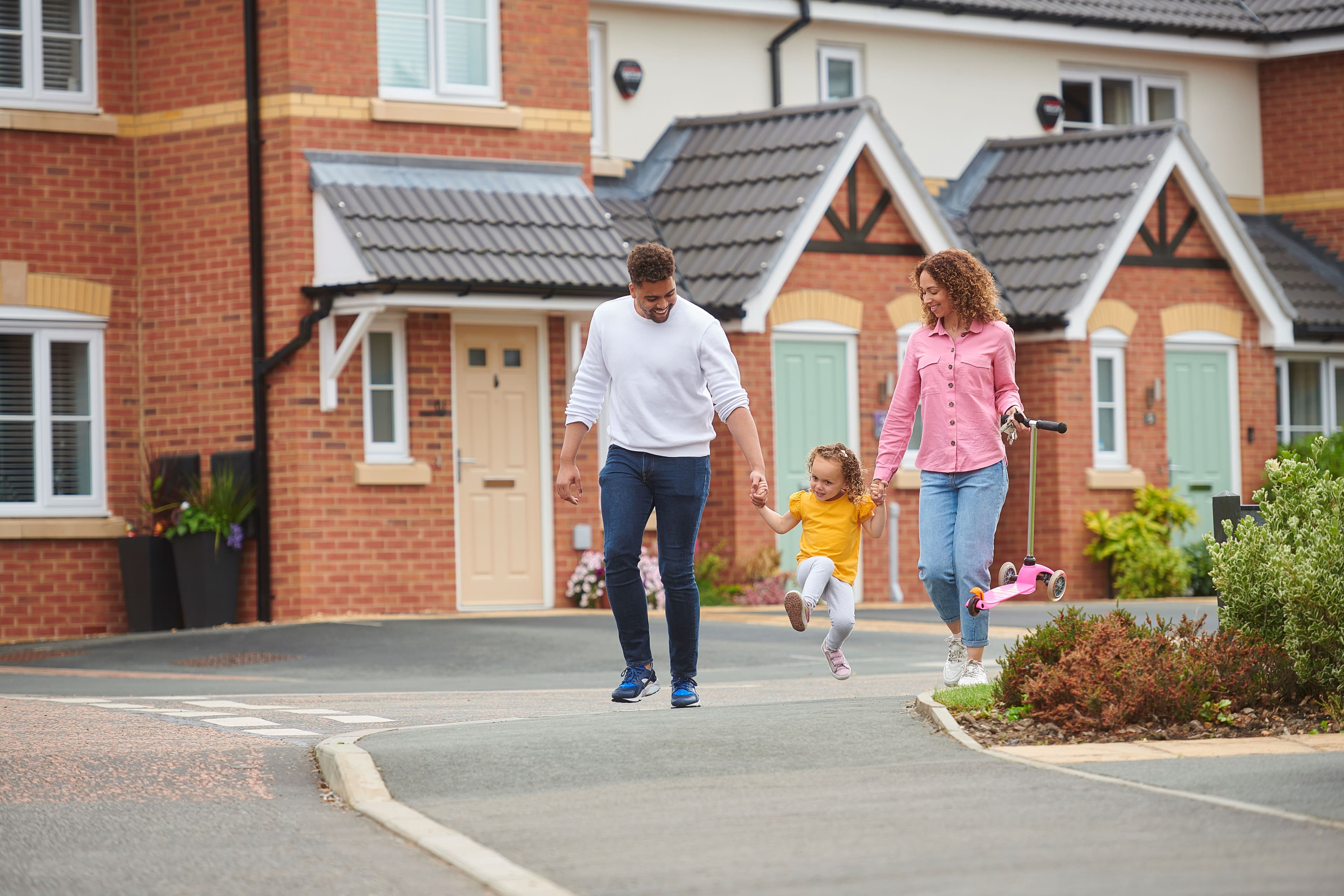 Family walking on their new build home estate